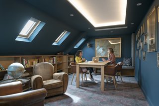 Cove lighting is found interspersed throughout the office to help elevate the low ceilings and bring light into previously dark spaces.