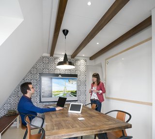 With a traditional mansard roof and exposed beams, the office resembles a quaint attic loft that's synonymous the city's architecture.