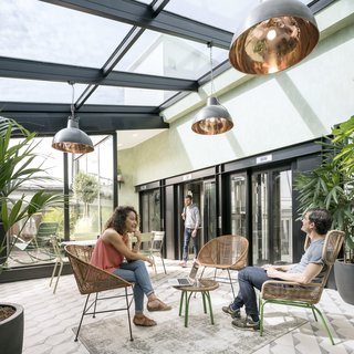 Stepping out of the elevator on the sixth floor, visitors are transported into a luminous, vegetation-filled solarium. 
