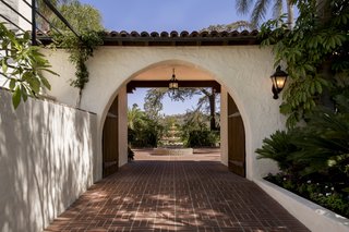 Historic charm abounds throughout the property with terracotta tiled arches and white stucco walls. 