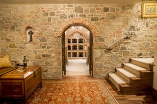 The wine cellar was formerly a speakeasy. Crafted from imported Italian brick, it has a 360-bottle capacity and features a completely dedicated thermostat and humidifier with a hand-forged, 1000-pound custom door. 
