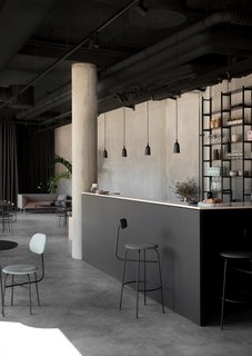 "The space draws heavy inspiration from strong materials such as concrete and steel," explains Norm Architects.