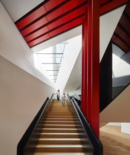 Part of an Epic Expansion, London’s V&A Museum Paves its Courtyard With 11,000 Porcelain Tiles - Photo 5 of 10 - The engineering and construction challenge is made visible to the public by steel columns and a beam that's painted in vivid international orange. It literally holds the weight of history and the Museum’s priceless collections above. 