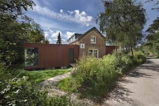 A New Book Examines the Art of Breathing Life Into Forgotten Architecture - Photo 7 of 16 - This project by Zecc Architecten BV involved the extension and expansion of a railway cottage that dates back to 1867. The home is situated along a train line next to the Sanpoort-Nord station—which is only a 25-minute train ride from Amsterdam—and a national park. The original brick structure was left virtually untouched. 
