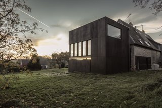 A New Book Examines the Art of Breathing Life Into Forgotten Architecture - Photo 9 of 16 - When building the extension of this early 20th-century home in Senneville-sur-Fécamp, France, Ziegler Antonin Architecte left the main house untouched. They added a dark rectilinear structure, which contrasts with the original light brick home, creating a total escape for the homeowners in the form of a light-filled library. 
