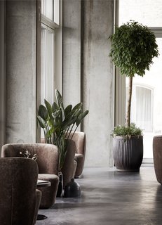 Floor-to-ceiling windows offer views of the canal and the old city center beyond. 