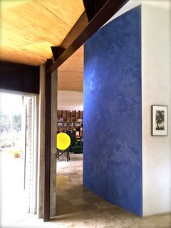 Set on 40 Enchanting Acres in Ojai, This Award-Winning Green Residence Is on the Market For $2.2M - Photo 5 of 10 - Special attention was given to the selection of the finishes including this striking blue Marmorino plaster wall. The home’s unique floors are made from 400 million-year-old fossil-filled limestone imported from Germany.