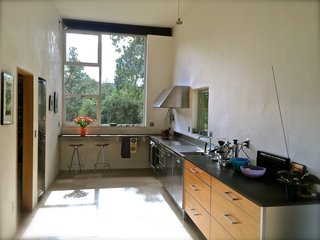 Set on 40 Enchanting Acres in Ojai, This Award-Winning Green Residence Is on the Market For $2.2M - Photo 6 of 10 - The bright and spacious kitchen offers an European-designed module with energy-efficient appliances.