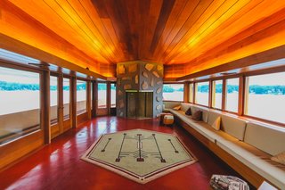 Large windows wrap around the home's exterior, offering stunning views from every room. It also features six wood-burning fireplaces. 