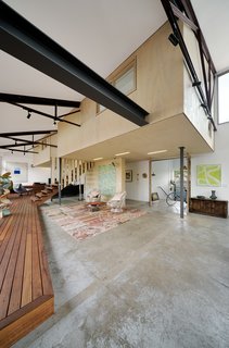 Mezzanine-level rooms float within the original volume of the warehouse. The existing floor slab was also preserved, partially due to restricted site access, but also for its inherent character.