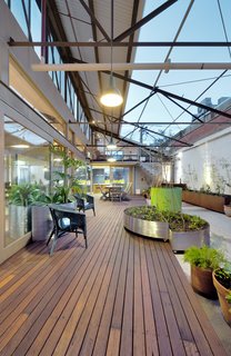 To overcome the waterproofing issues that come with having an internal courtyard, a hob was created around the perimeter and a new slab was constructed that drains water out to a central storm-water pit. The raised hob and slab are disguised by a new recycled timber deck that straddles the interior and exterior spaces, blurring the transition between the indoor and outdoor areas. Movable planter boxes made out of Cor-Ten steel were introduced to create a garden. 