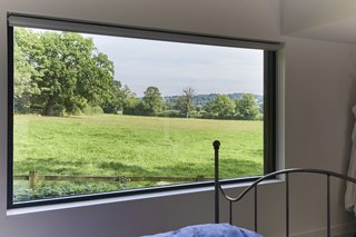 The master bedroom suite boasts a large picture window with far-reaching rural views.