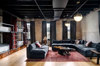 The "Romper Room" is outfitted with eight single beds tucked into handcrafted bunks. 