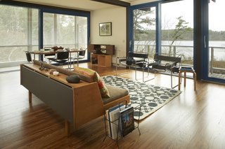 The home is perched above the pond and features panoramic views of the natural surroundings. 