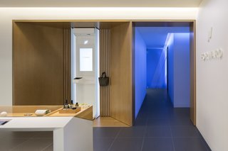 A Healthcare Start-Up Combines Modern Design With Top-Notch Technology and Care - Photo 7 of 11 - A wood display case features wearable sensors, vitamins, supplements, and skincare products that are offered to members at discounted rates. 