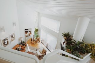 The entrance to the home looks down on the living room with a bright bird's-eye view.