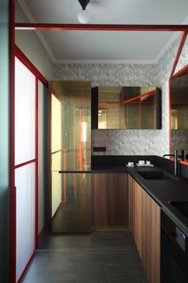 In the kitchen, the doors are made out of brass and eucalyptus wood while the lighting is from Atelier Areti. The countertops are made with high-thickness laminate Polaris by Abet Laminati and were designed by Marcante-Testa and built by Materia Design and Om Project. The faucets are from Bellosta. 