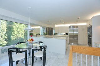 The bright and open contemporary kitchen leads out to the back patio. 