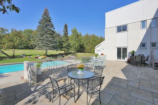 A 30' x 40' patio leads to 20' x 40' in-ground concrete swimming pool. 