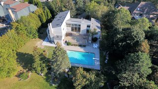 The swimming pool area is thoughtfully landscaped with large rocks interspersed with blue spruce, green spruce, pines, maples and oak trees.