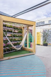 The designers have incorporated nature via a wall of greenery creating a cozy nook with a sense of privacy and a relaxed vibe.