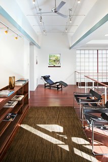 The library features high ceilings complete with ceiling fans and ample lighting. 