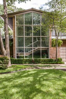 Floor-to-ceiling windows provide ample natural light and look out onto the landscape.