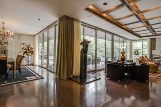 A series of sliding doors frame the exterior landscape and lead out to the patio. 