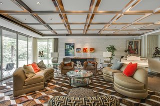 The living room area features recessed lighting and terrazzo flooring with brass filings. 