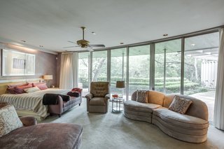 Designed for privacy, the master suite features giant sectional sliding doors and windows along with a unique geometric curved layout. 
