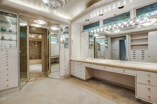 Also included in the master suite are a walk-in closet with built-in shelving, and a his/her master baths.