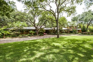 Beautiful, organic landscape was designed naturally around the trees to overlook a nearby pond. 