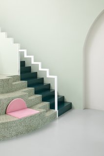 When Melbourne-based studio Biasol was tapped to design the interiors of a cafe in Chengdu, the capital of China's Sichuan province, the design firm studied the director's singular aesthetic sense, and The Grand Budapest Hotel in particular. The appropriately named Budapest Cafe unfolded into a fantasy-filled escape—much like Anderson's mythical hotel. Stairs lead to a mezzanine level that provides a view from above, while a decorative staircase leading nowhere is a recurring theme, popping up at the end of the long marble bar, integrated into shelving, and above a faux fireplace.