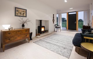 A sitting area with a stove creates a cozy sense of hygge.