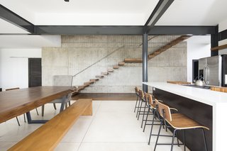 A floating staircase leads to the second level of the home. 