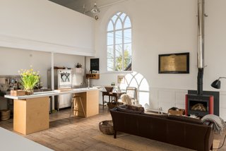 A wood-burning stove adds a cozy element. 