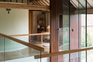The converted barn home exhibits a striking juxtaposition of wood and glass. 