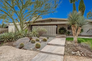 The front garden features native landscaping.