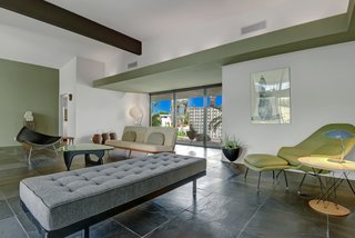 The entire living, dining, and entry area features dark slate flooring.