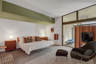 The guest bedroom looks out on the pool area.