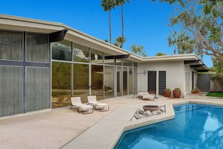 The pool area showcases a Pebble-tec saltwater pool, fountain, succulent garden, and fire pit. 