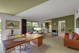 Currently used as a study and guest suite, a portion of the home could be used as a separate residence or in-law suite with a fully equipped kitchen and enclosed private patio, yard, and orchard access. 