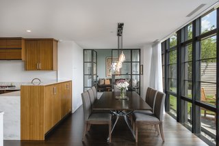 The kitchen and dining room are flooded with natural light and offer garden views.