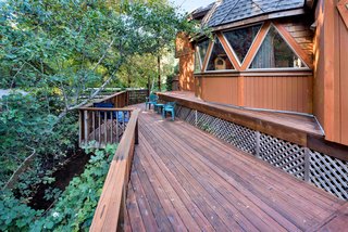 The deck looks out over a forested section of land. 