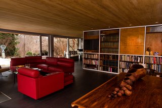 The open-plan living room features built-in bookshelves. 