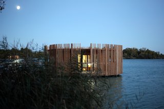 After sunset the effect is reversed, and a radiating internal glow emerges from between the wooden slats. 