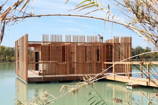 A view of the surrounding wraparound deck and wooden privacy screens