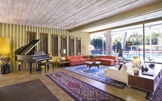 A Luminous Palm Springs Midcentury Asks $3.35M - Photo 3 of 16 - Interiors feature Williams’ iconic architectural details, including natural teak wood paneling, built-ins, wood ceilings, slump stone walls and fireplace, clerestory windows, board-and-batten redwood siding, and many original fixtures. 