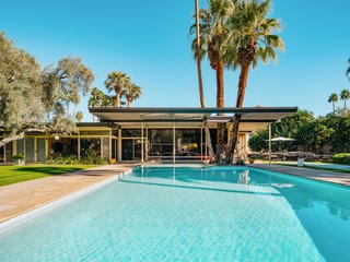 A Luminous Palm Springs Midcentury Asks $3.35M - Photo 11 of 16 - The large L-shaped estate looks out on a large pool and a luxurious outdoor area perfect for entertaining. 