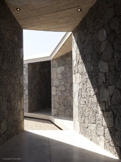 The diagonal patios and sloping roof create angular shadows. 